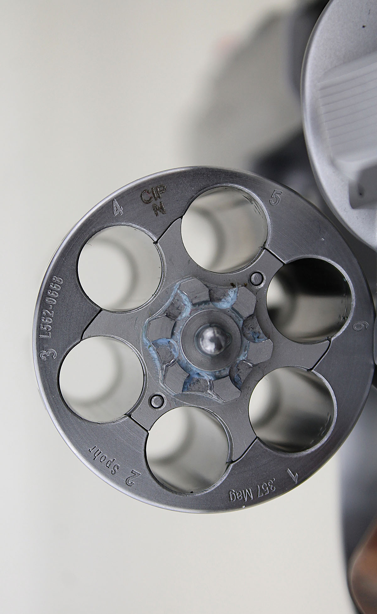 Chambers are numbered, and the cylinder is serial-numbered to the revolver frame.